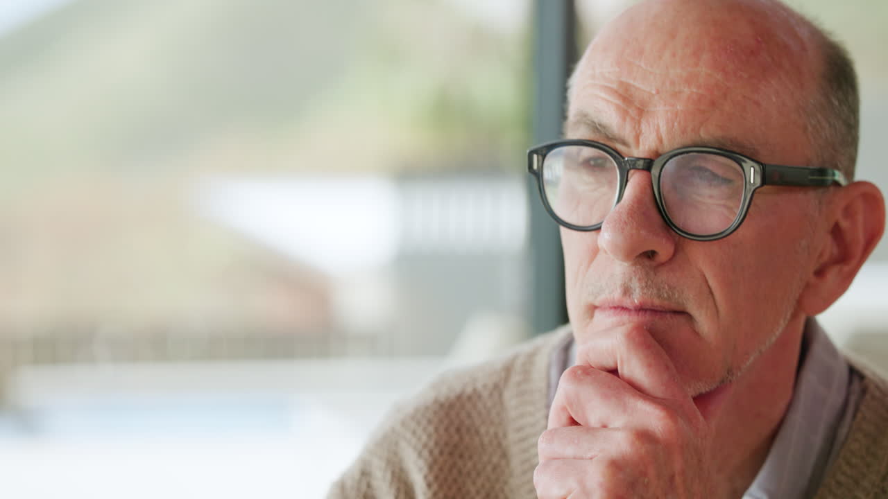 Close-up of a Pensive Senior Man Thinking with Hand on Chin