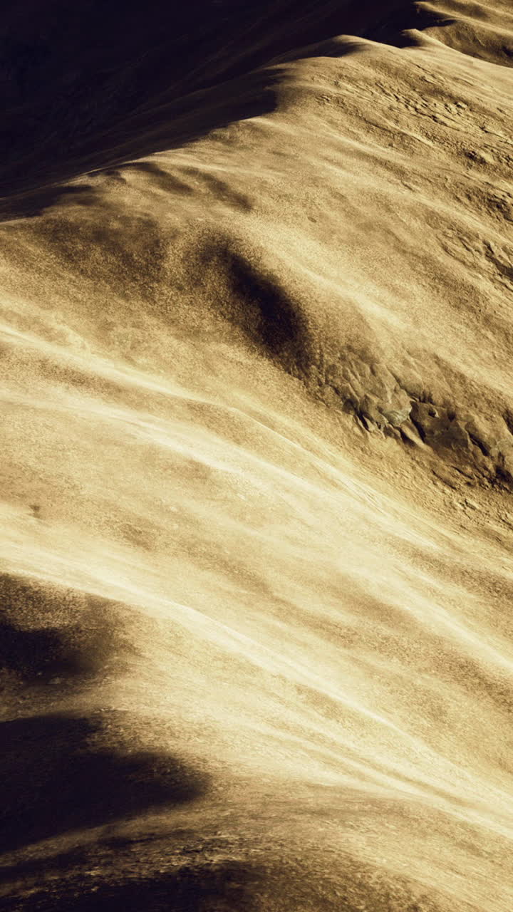 Golden sand dunes span a vast desert showcasing natural patterns
