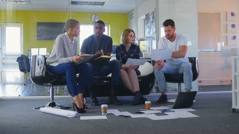 young mixed race business team discussing over documents in modern office 4k