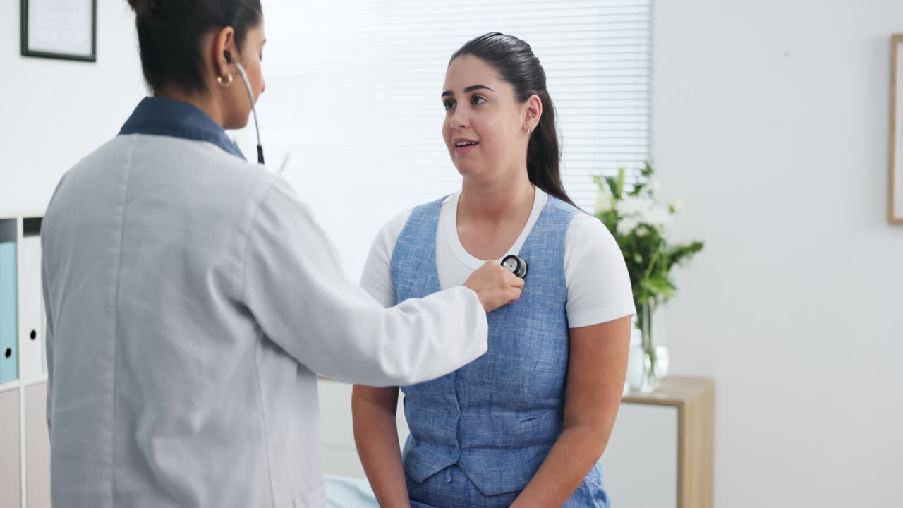 Female Doctor Examines Patient's Chest with Stethoscope in Clinic