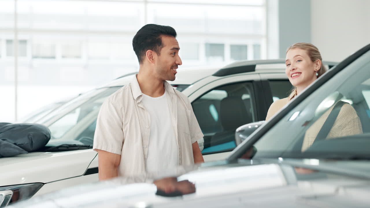 A couple shopping for a new car at a dealership
