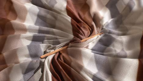 wrinkled fabric with wooden stick