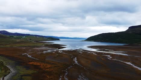Drone-shot-of-scottish-dried-up-lake-with-mountain-view
