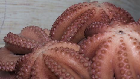 close up hot cooked octopus spinning on table selective focus.