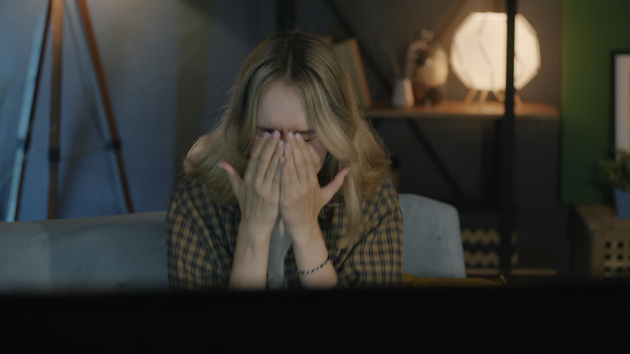 Woman watching TV, surprised expression