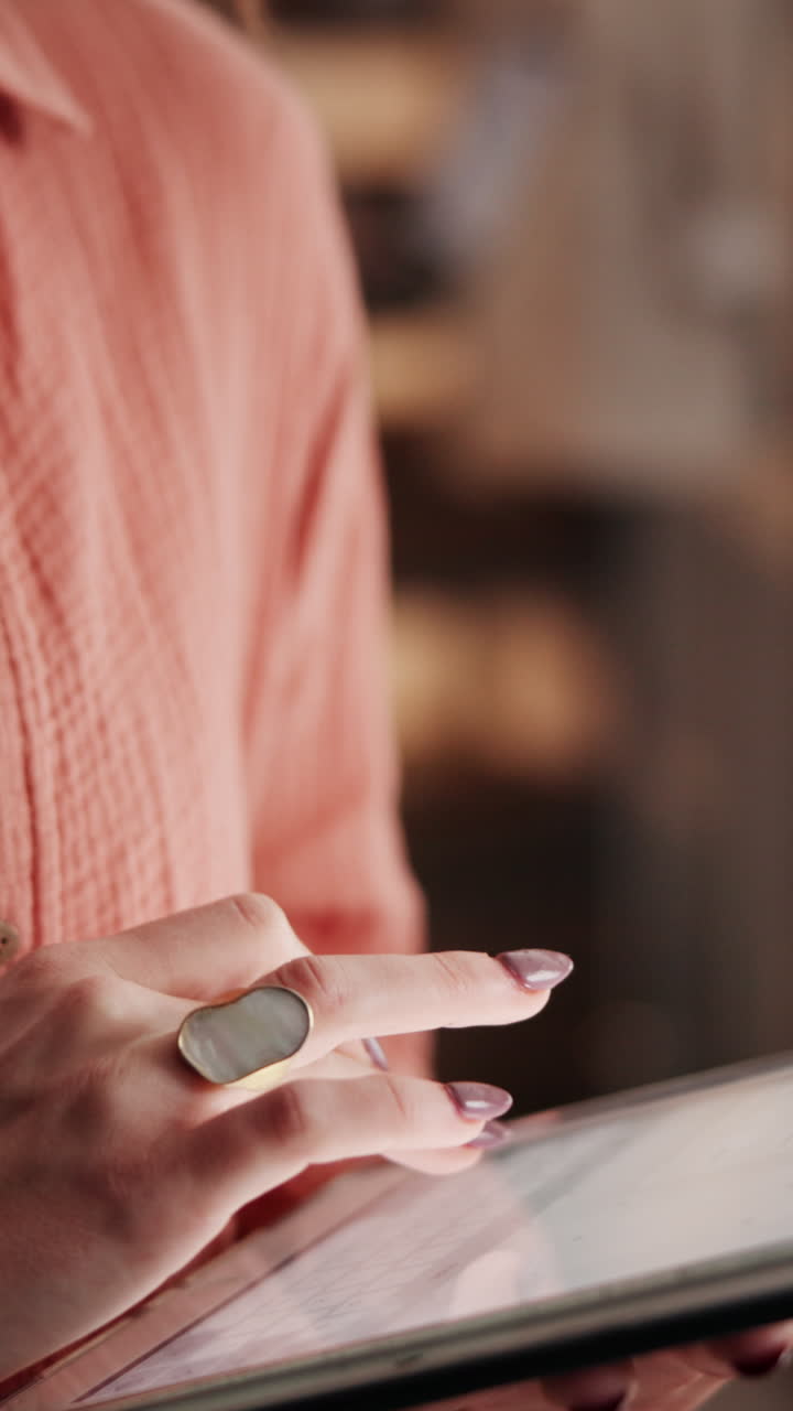 Close-up of Person's Hands Tapping and Scrolling on Digital Tablet