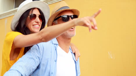 Smiling-couple-sitting-on-a-bike