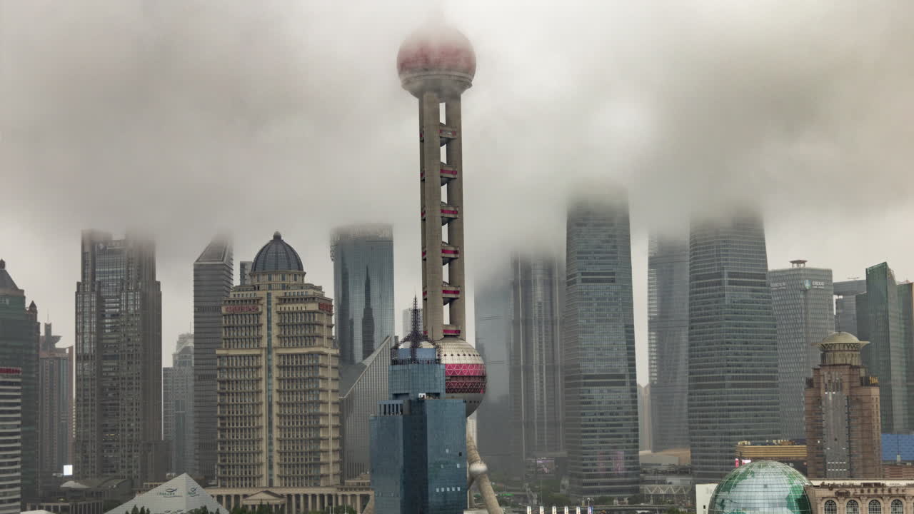 SHANGHAI, CHINA - 11 JUNE 2025 : Timelapse of the amazing Shanghai city skyline from a high vantage point on a foggy cloud covered day