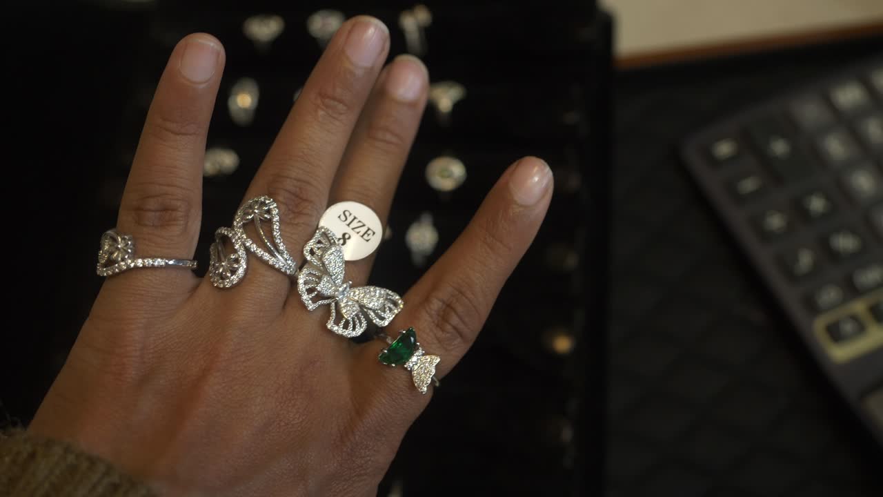 Closeup of designer silver finger rings studded with lab grown diamonds at a jewellery shop