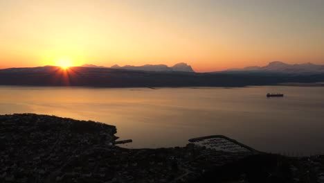 Aerial-view-of-sunset-over-city-by-the-ocean