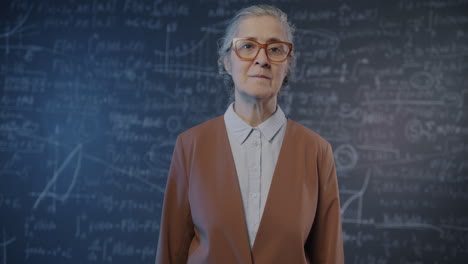 teacher in front of a chalkboard