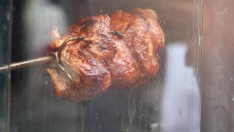 golden roasted chicken on a rotisserie