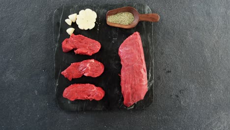 raw meat and ingredients on the board