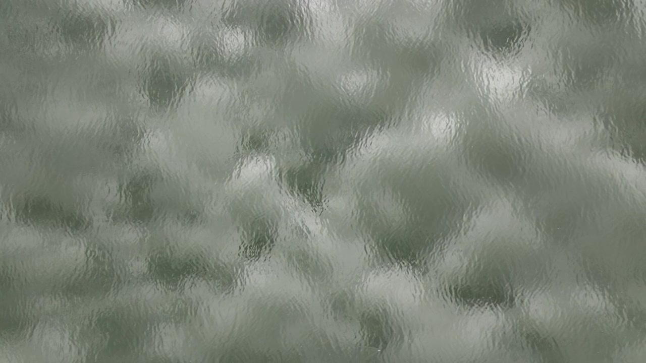 Blur view of clouds reflecting on Mississippi river in USA on a cloudy day.