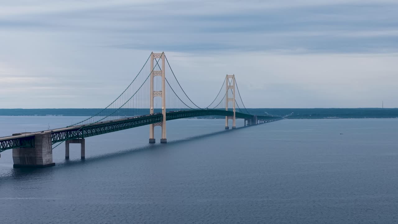 Aerial drone footage of the Mackinac Bridge stretching across the Straits of Mackinac in Michigan’s Upper Peninsula