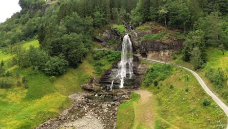 Steinsdalsfossen-is-a-waterfall-in-the-village-of-Steine-in-the-municipality-of-Kvam-in-Hordaland-county,-Norway.-The-waterfall-is-one-of-the-most-visited-tourist-sites-in-Norway.