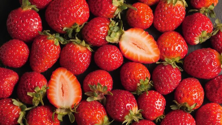 A lot of red and ripe strawberries rotating, closeup
