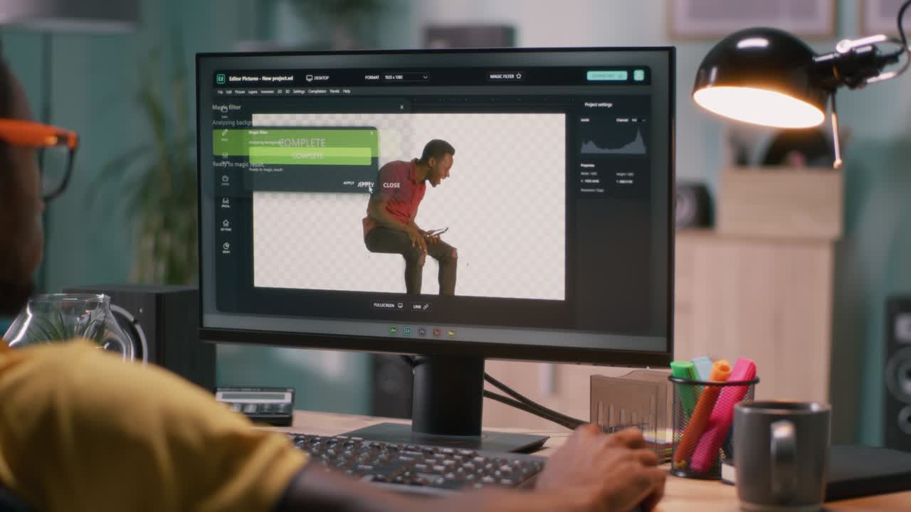 Black male editing chromakey background on video