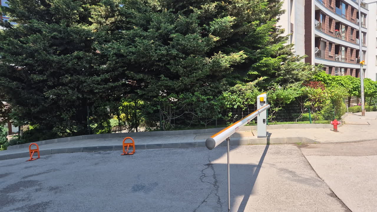 Outdoor parking barrier is coming down closing the entrance.