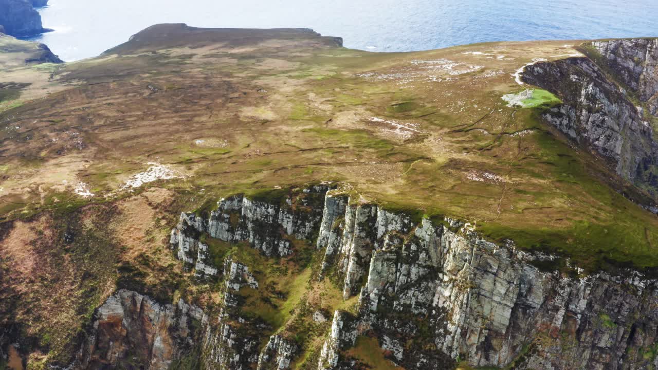 Aerial view of Horn Head with Napoleonic ruins overlooking steep cliffs and the Atlantic on a clear summer day