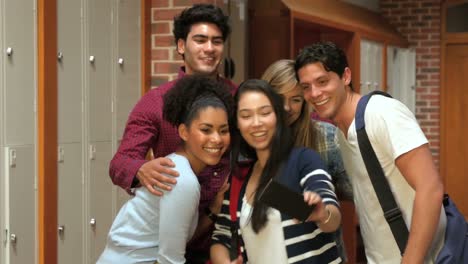 happy students taking selfie in locker room