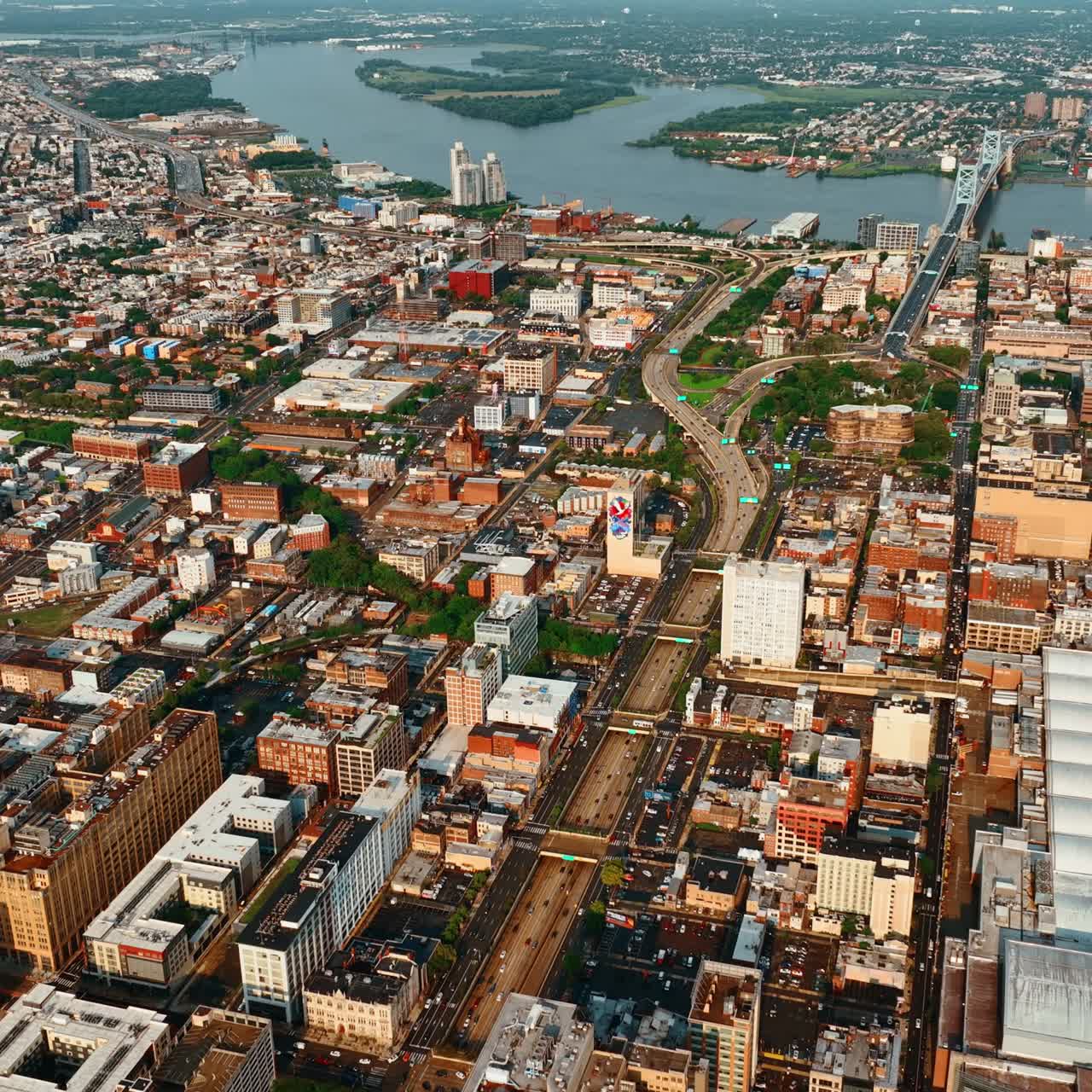Sunny cityscape of Philadelphia, Pennsylvania, USA. Sight of the bridge over the Delaware River at backdrop. Top view