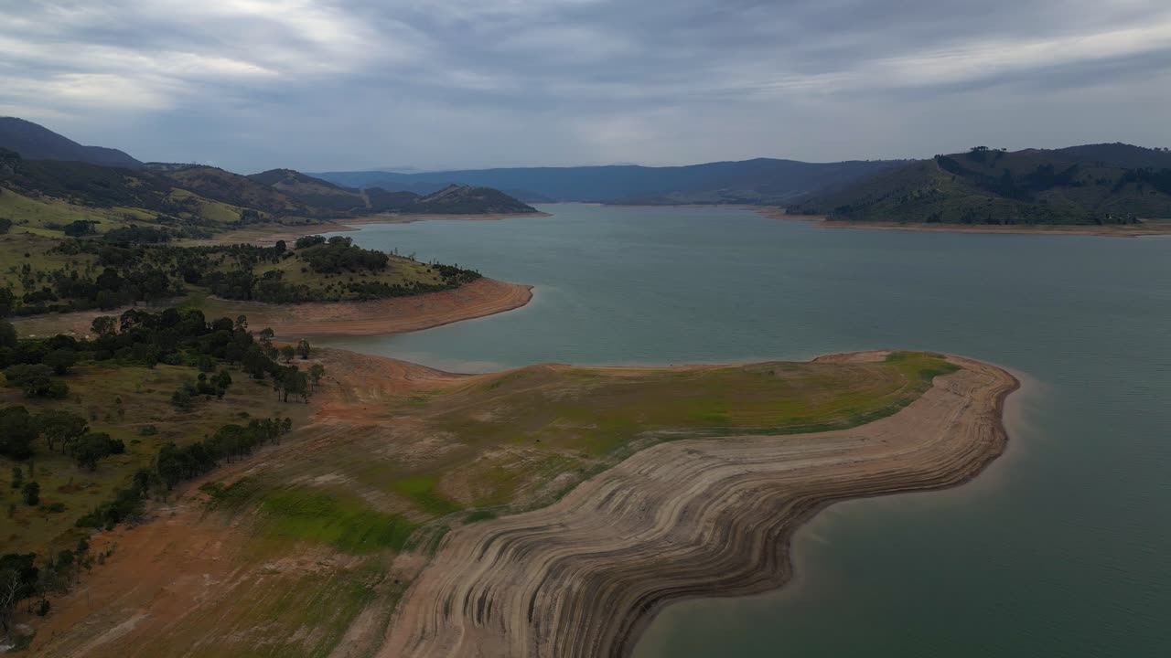 Right to left aerial view over Blowering Reservoir (dam) near Tumut in the Snowy Mountains Region of New South Wales.