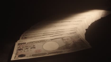 japanese yen fanned out on table, net filter, shallow focus