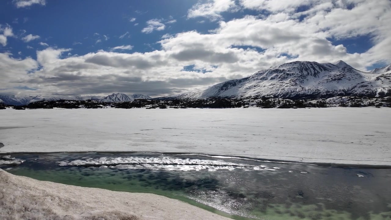 Sneeuwbedekte bergen en meer nabij Carcross, Canada, einde van de White Pass Spoorweg, prachtige turquoise wateren