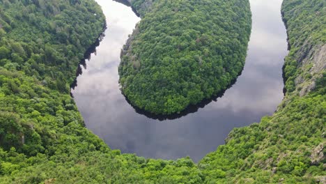 drone shot from viewpoint máj, iconic river bend surrounded by lush green forest