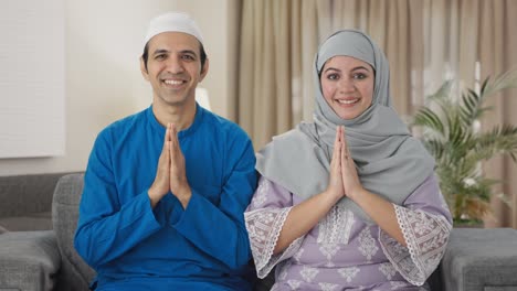 happy muslim couple doing namaste