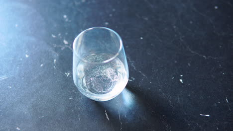 Close-up-slow-motion-pouring-fresh-drink-water-into-drinking-glass