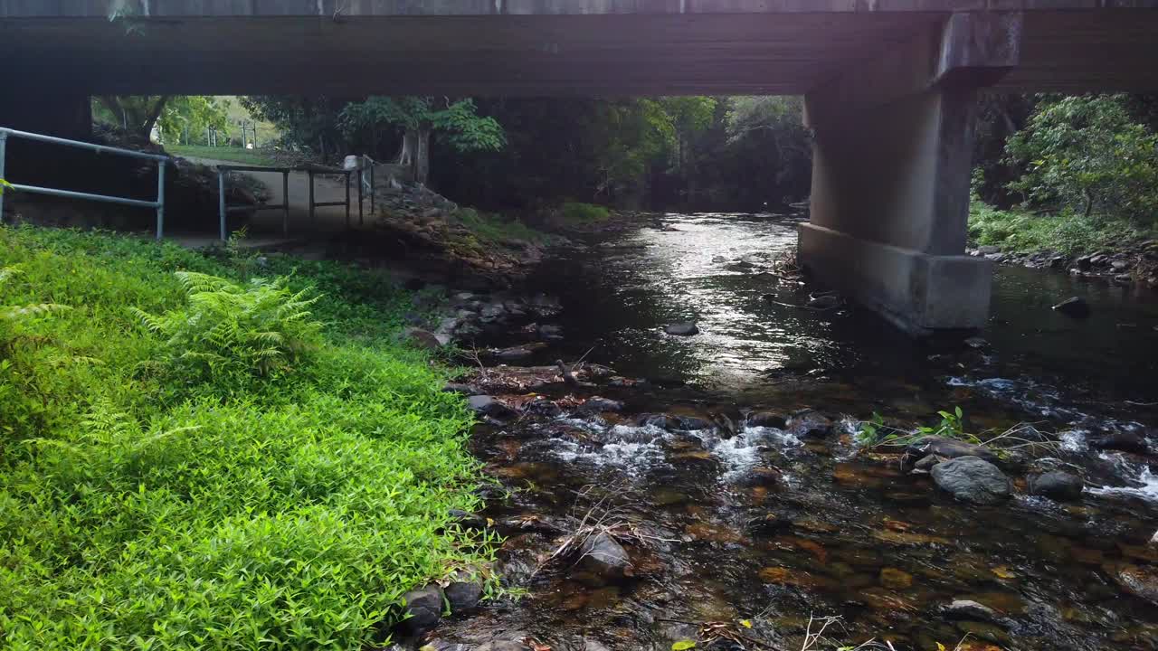 running creek and footpath under a bridge in normal speed