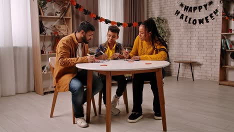 family drawing and coloring together for halloween