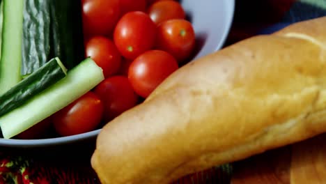 raw vegetable, tomatoes and loaf of bread