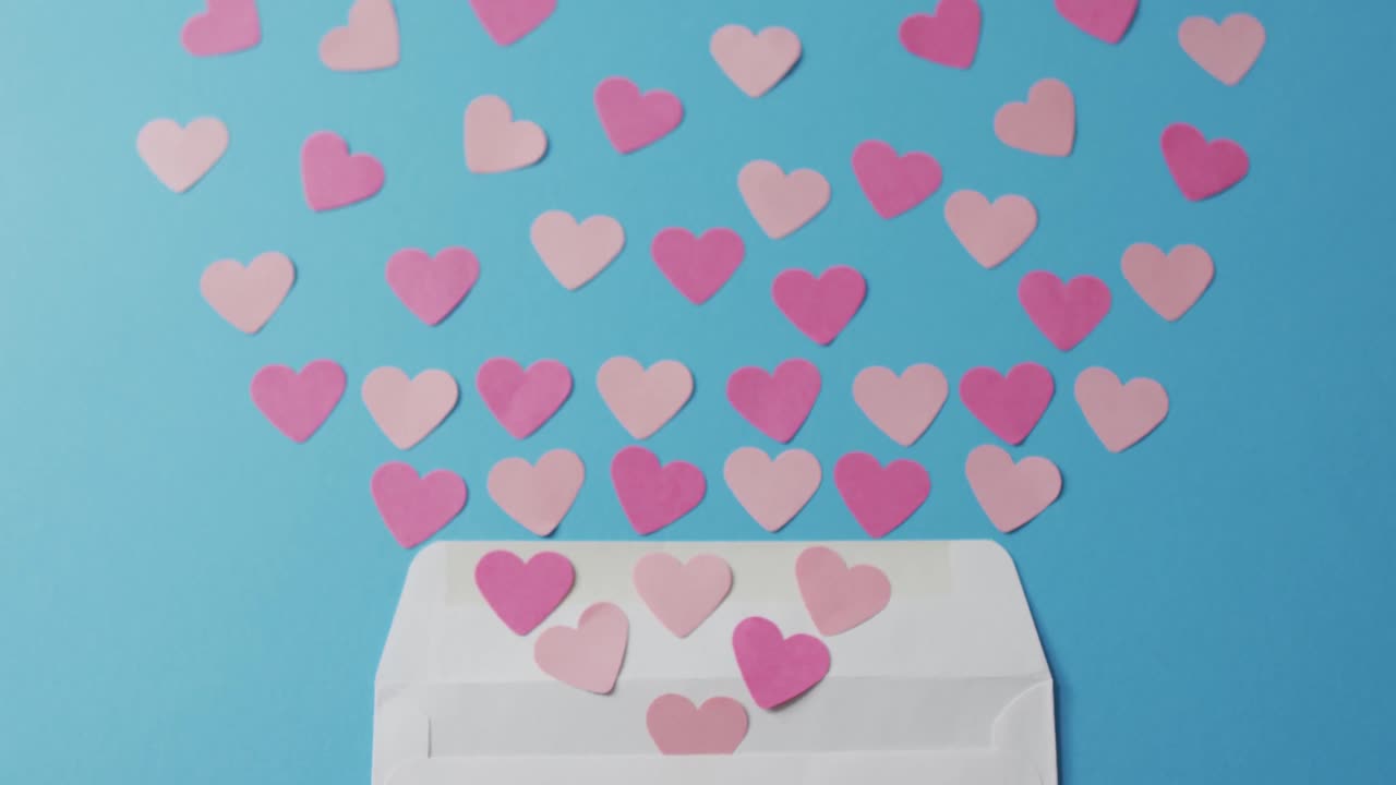 Envelope with paper hearts on blue background at valentine's day