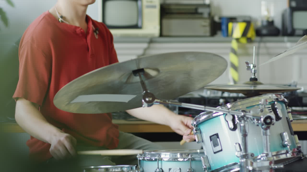 Young Man Playing Drums Indoors