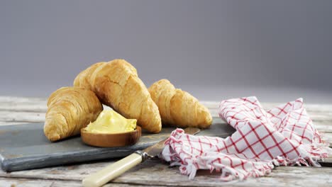croissants with butter and knife