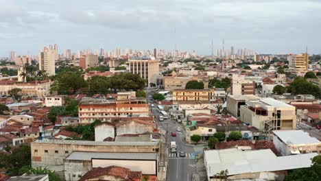 Dolly-in-aerial-drone-shot-of-the-European-downtown-of-the-tropical-coastal-capital-city-of-Joao-Pessoa,-Paraiba,-Brazil-with-old-skyscrapers-and-historic-buildings-during-golden-hour