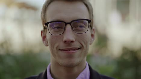 laughing blond man looking and talking to camera