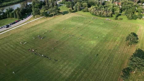 static drone shot of people playing ultimate frisbee games in summer park