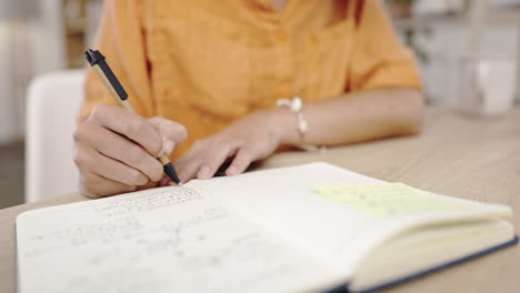 Woman-hands-writing,-home-study-desk