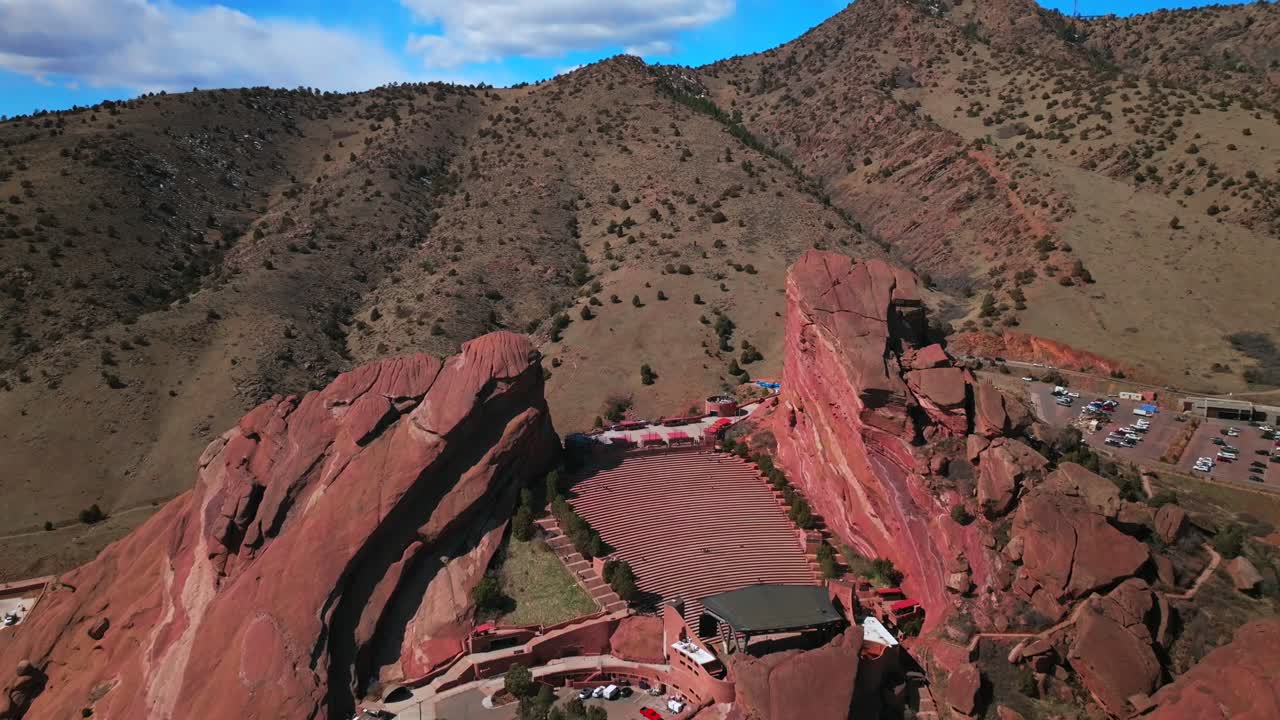 Red Rocks Park and Amphitheater Mount Morrison Colorado aerial drone mid winter music stage cars parking lot windy walking trails Trading Post sunny blue sky clouds stairs tourist destination forward
