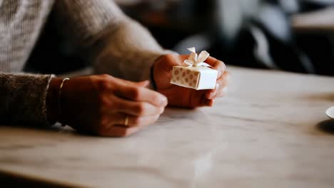 man holding a small gift box