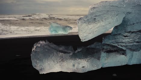 Timelapse-shots-of-crystal-clear-icebergs-on-black-sand-beach-in-Iceland