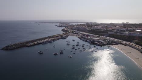 aerial orbiting shot of sines fishing port by vasco da gama beach, portugal