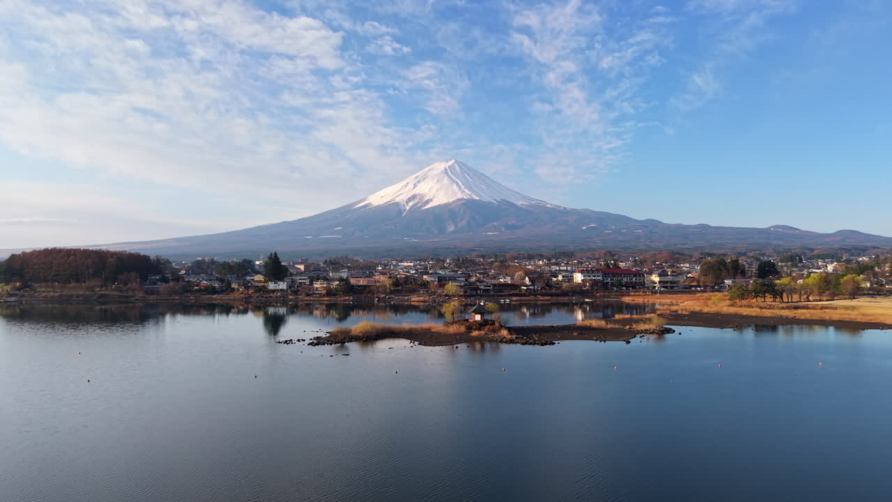 Aerial drone view of Lake Kawaguchiko near the Fujikawaguchiko town in Japan with Mount Fuji on the background in daylight