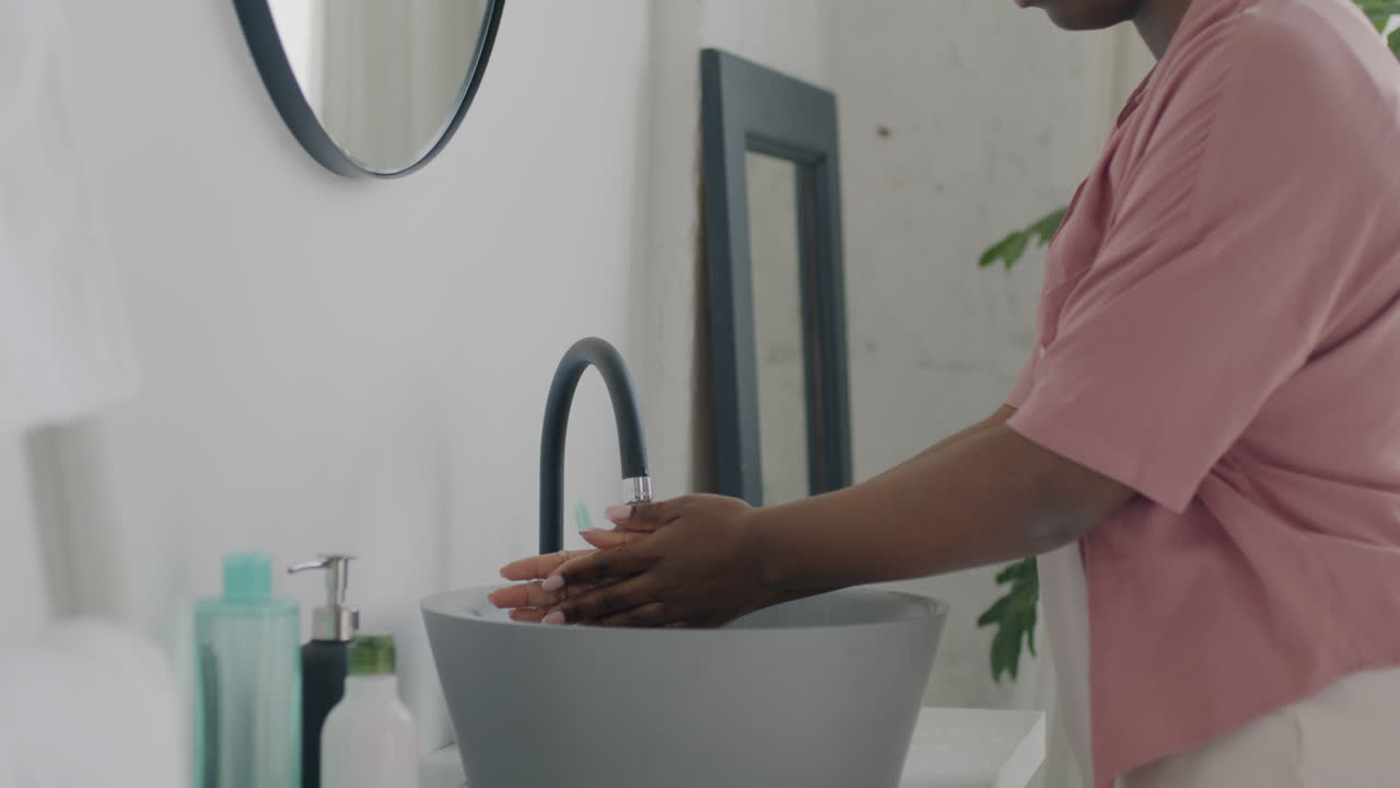 Woman Washing Face/Hands in Bathroom
