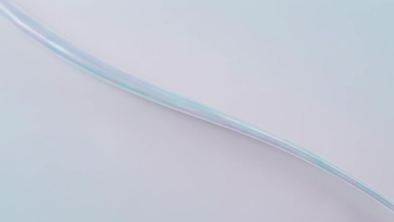 Entering upper-left, thin ribbon sweeping diagonally across pale backdrop, showing blue-pink sheen