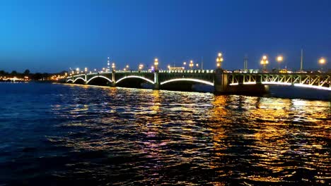 night view of a bridge over a river in saint petersburg, russia